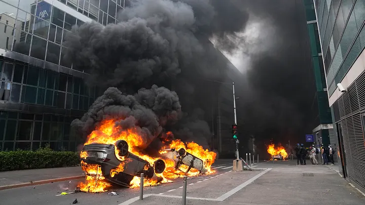 Cars burn after a march for Nahel on June 29, 2023, in Nanterre, outside Paris. (AP Photo/Michel Euler)

