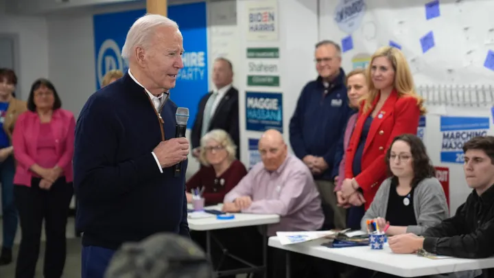 President Biden, left, speaks to supporters during a visit to a campaign field office,