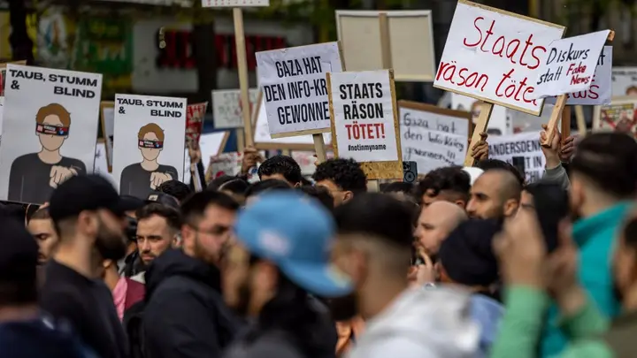 Participants in an Islamist demonstration hold up posters.