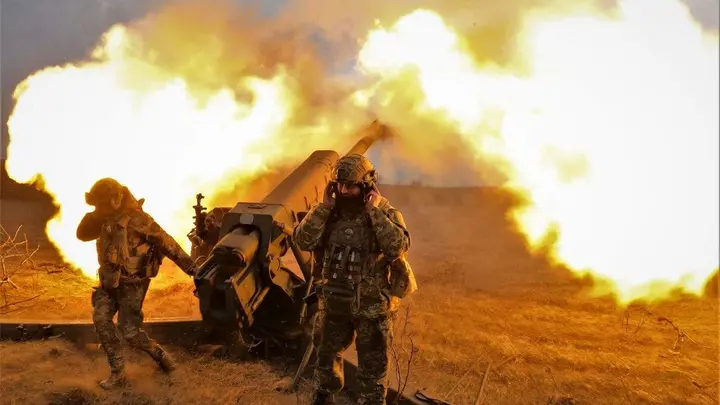 Ukrainian servicemen fire with a D-30 howitzer