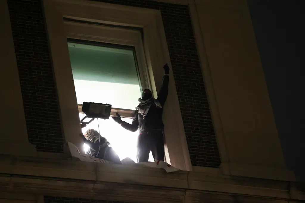 anti israel protesters-gesture-window-hamilton-hall