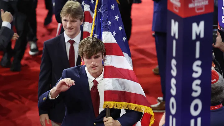 Attendees carry American flags at RNC