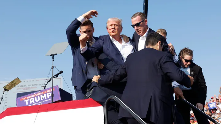 Former President Donald Trump is rushed offstage after shots were fired during a rally on July 13, 2024